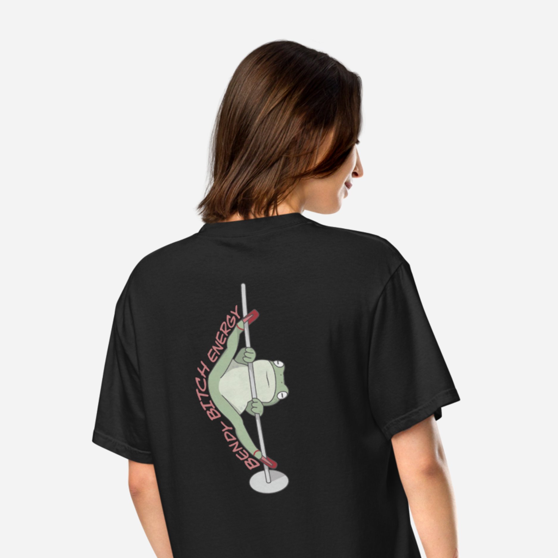 Woman facing away wearing a black tshirt with a big graphic of a frog in high heels doing the splits on a pole. Text accompanying the design says 