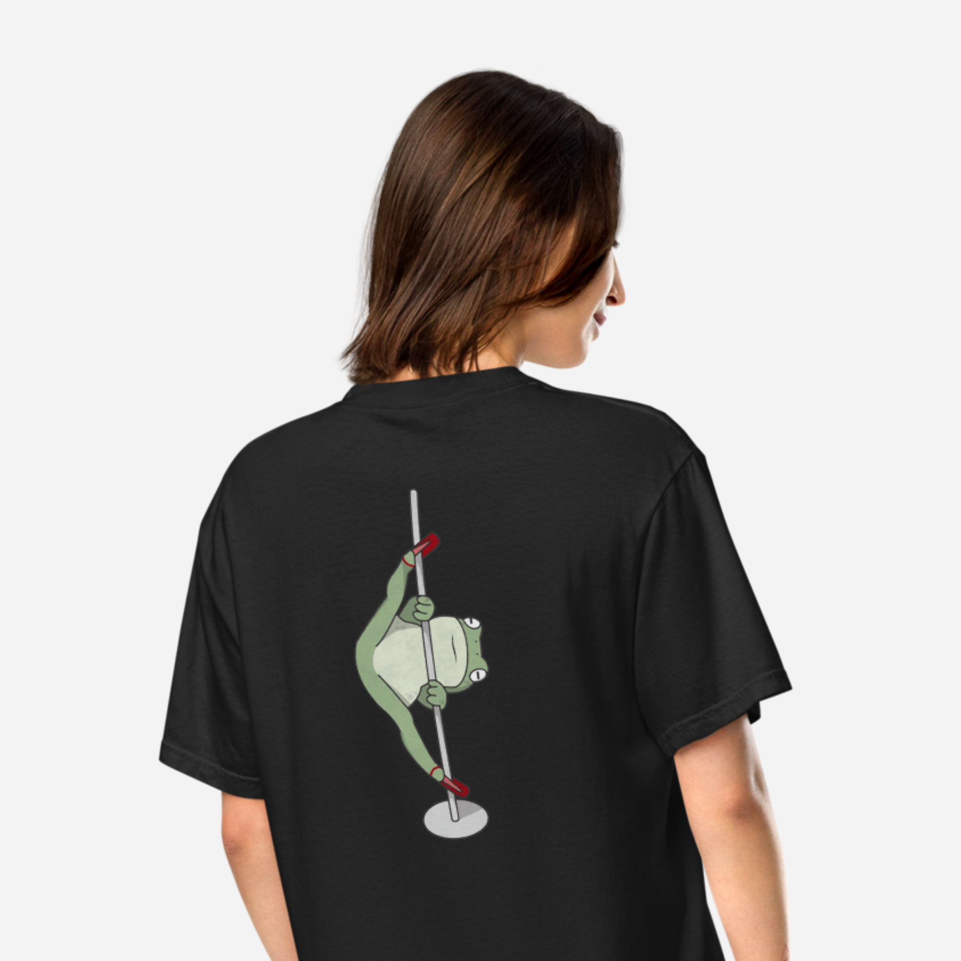 Woman facing away wearing a black tshirt with a big graphic of a frog in high heels doing the splits on a pole. 