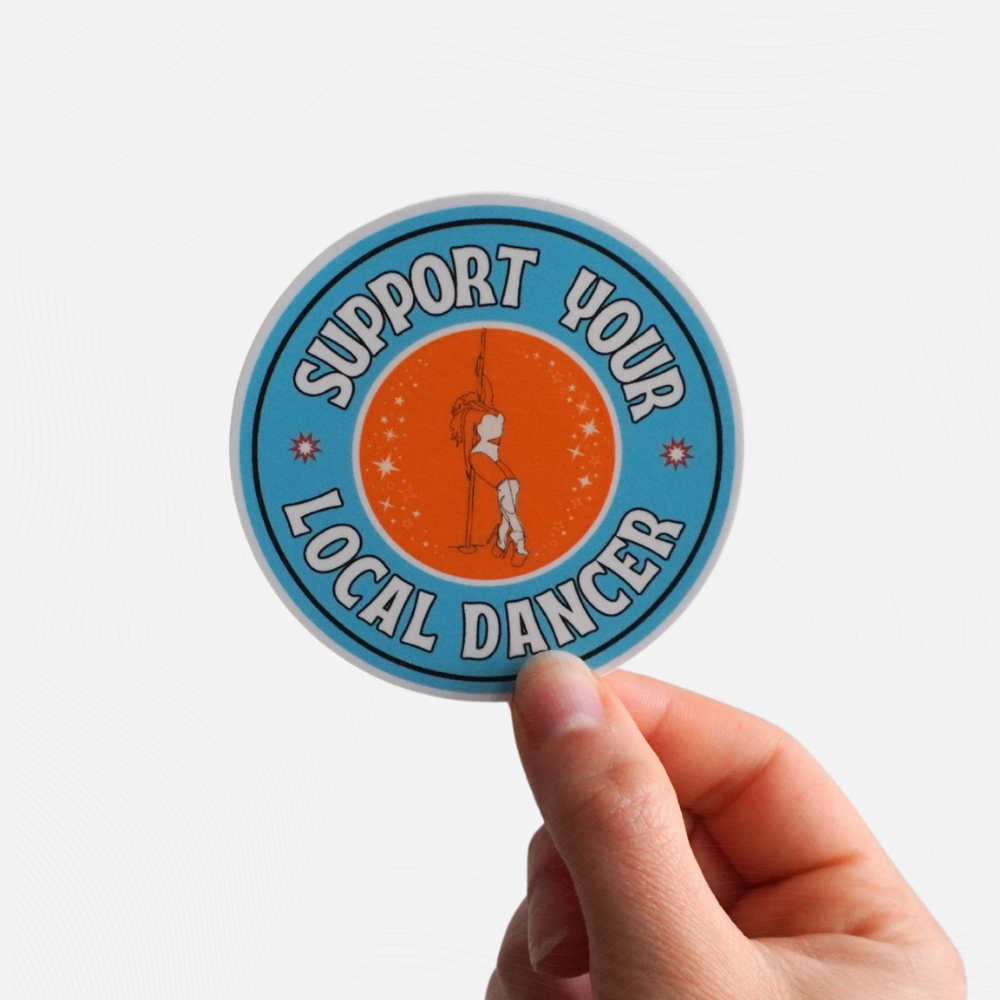 Sticker with 'Support Your Local Dancer' text held by a hand on a white background