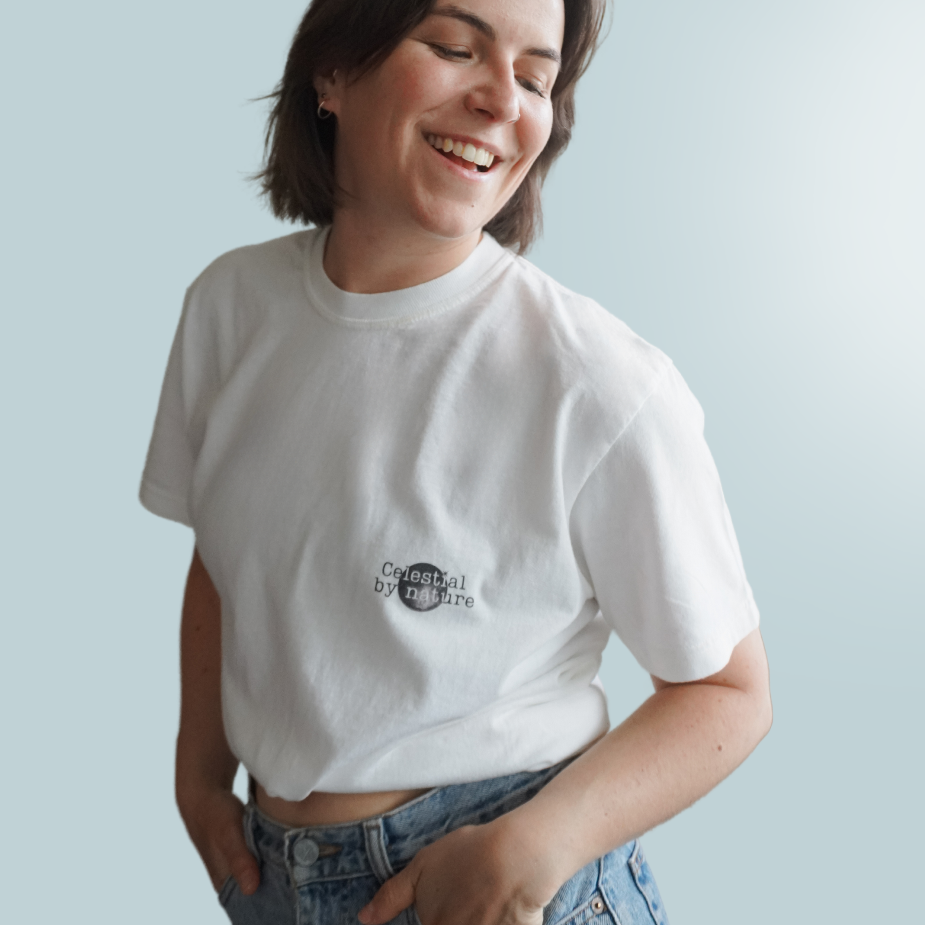 Woman wearing a white tshirt with a black and white design saying 