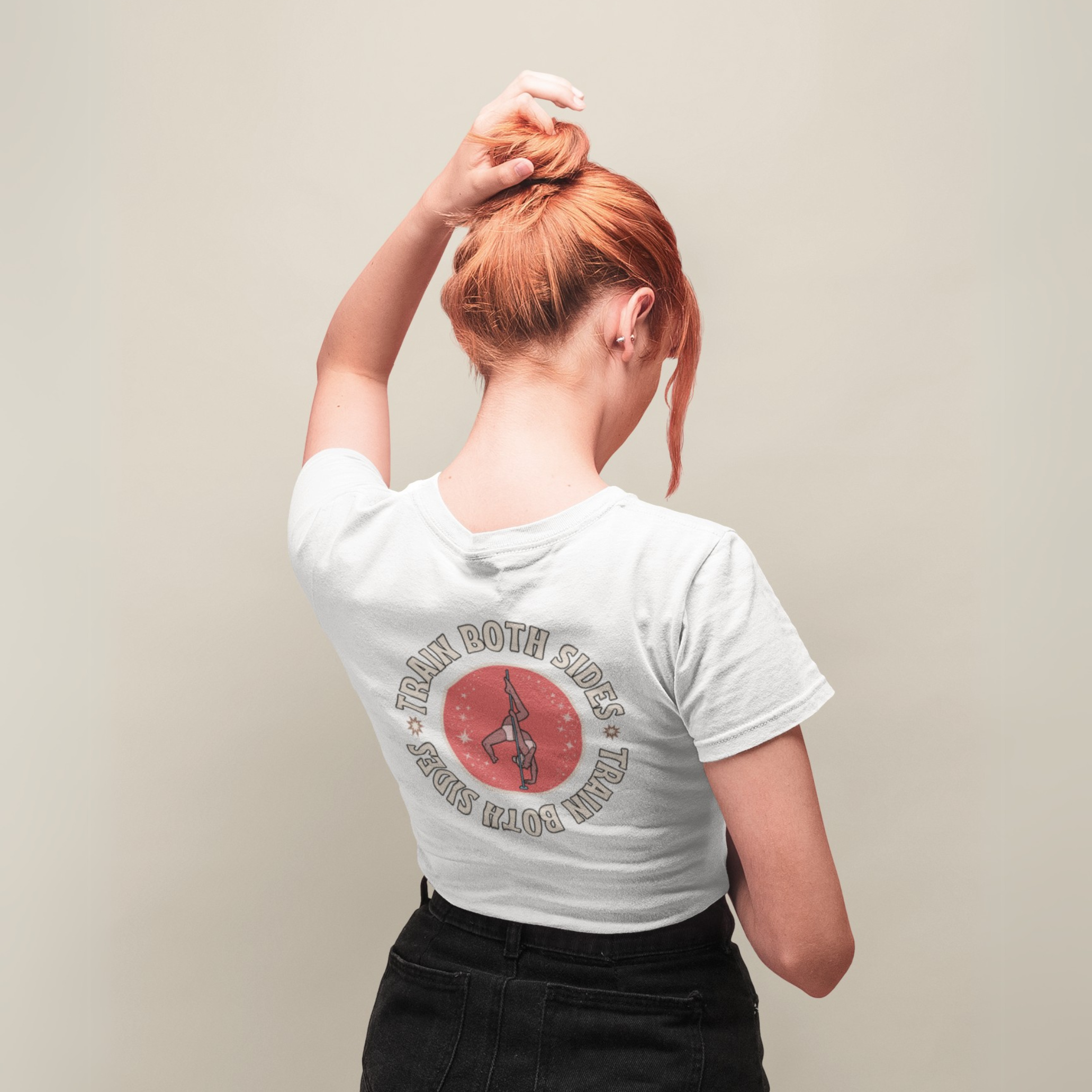 Woman facing the back, wearing a white tshirt with a graphic saying 