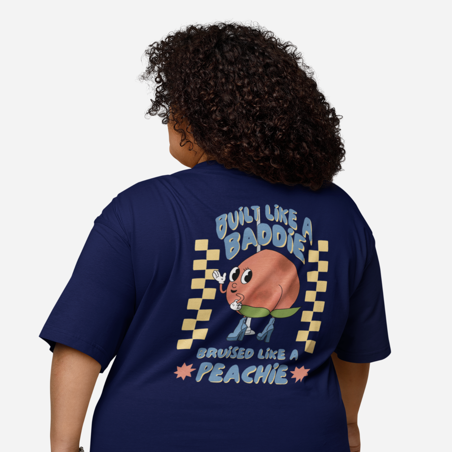 Person facing the back wearing a navy tshirt with a graphic of a cartoon peach. It says 