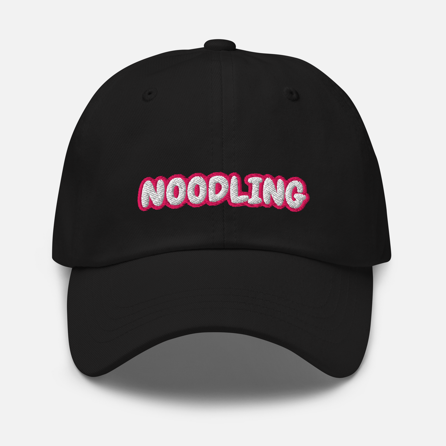 Black cap in front of a white background. The word "Noodling" is embroidered in white letters with a pink outline on the front of the cap.