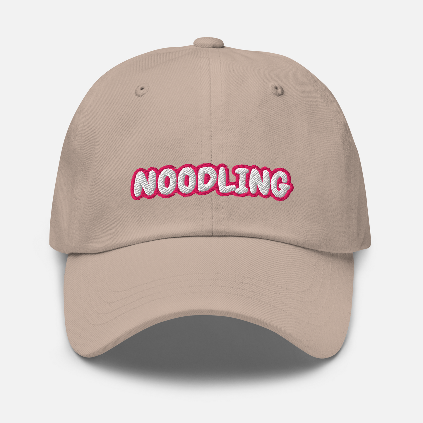 Beige cap in front of a white background. The word "Noodling" is embroidered in white letters with a pink outline on the front of the cap.