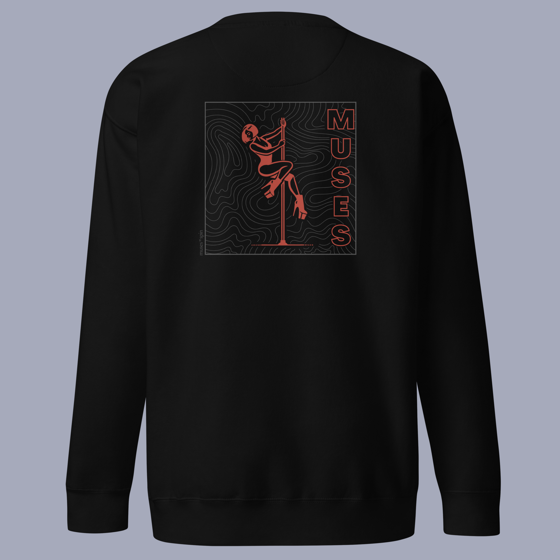 Black sweater with a dark red and grey design of a pole dancer and the word "Muses" on the side. The sweater is laid out in front of a grey background.